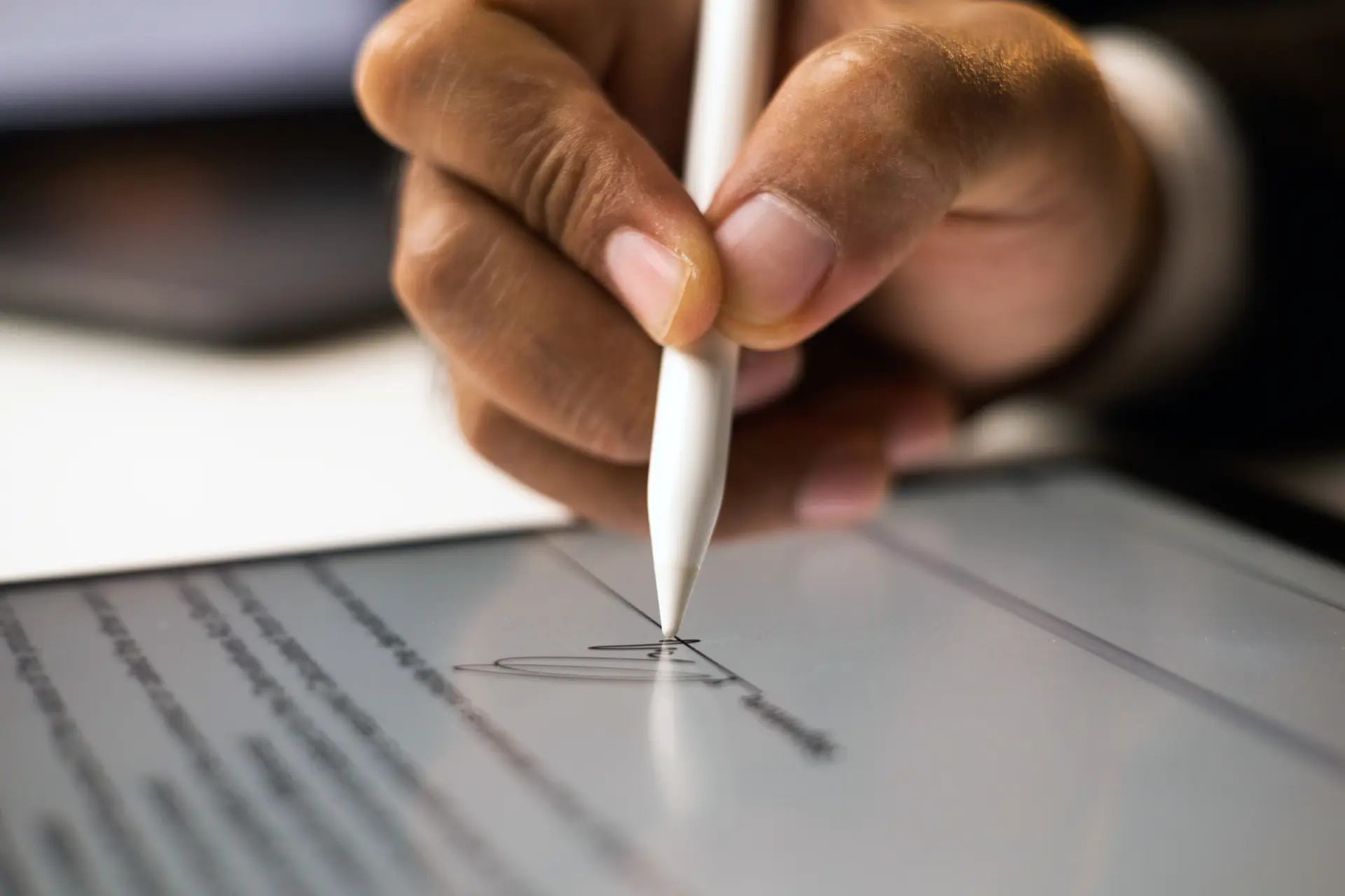 Customer providing electronic signature on tablet for repair shop service agreement